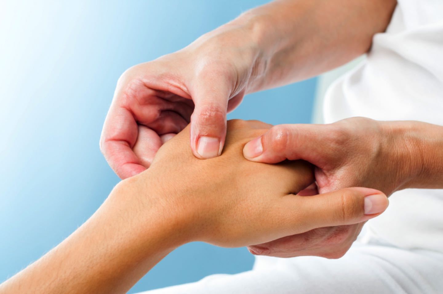 Macro close up of Therapist doing massage on female hand.Osteopath applying pressure on hand.