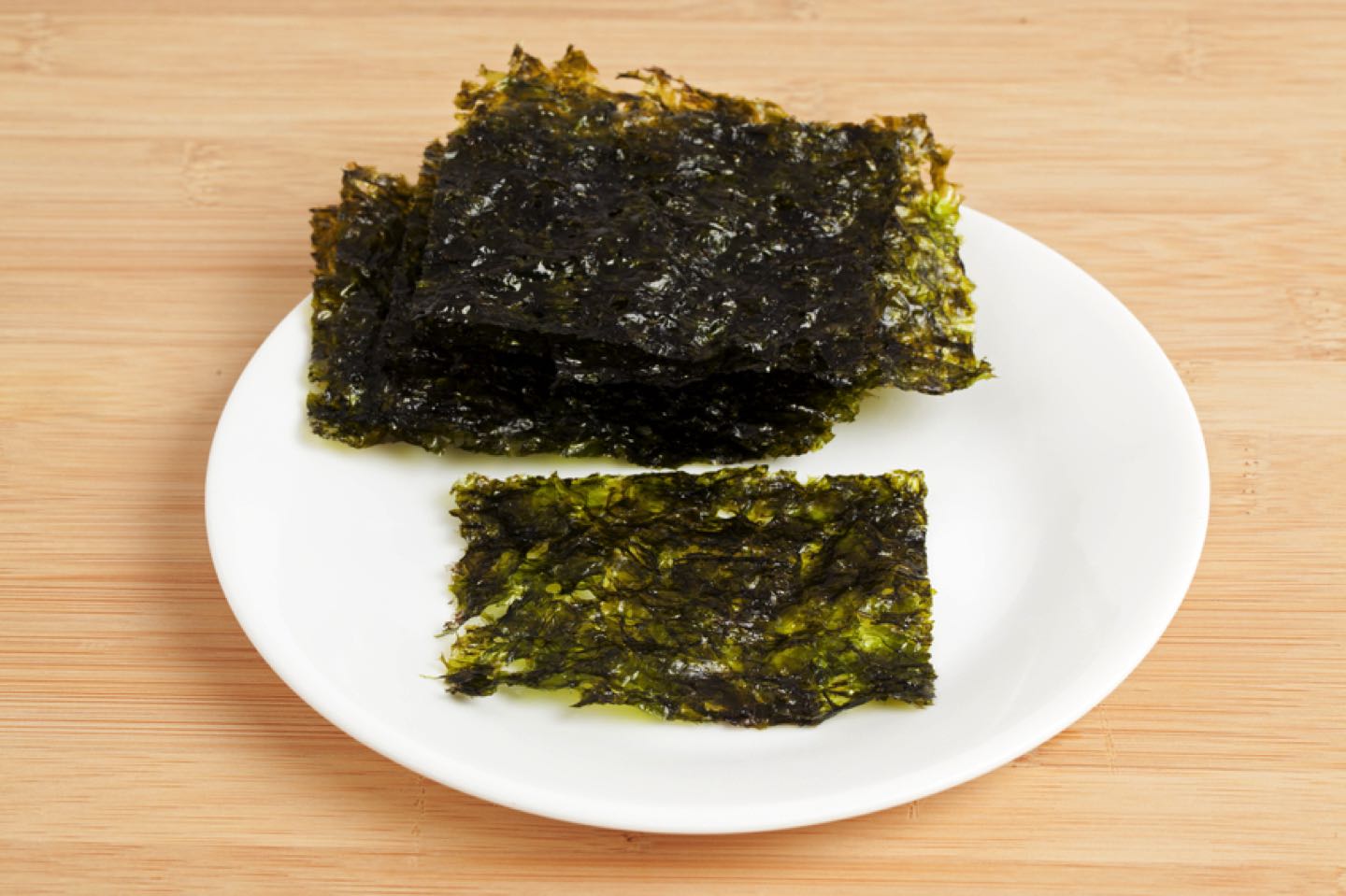 Close-up of a thin sheets of roasted seaweed. These thin sheets of seaweed are a low calorie, nutritious snack. Shot in studio with Canon 5D Mark II DSLR camera.