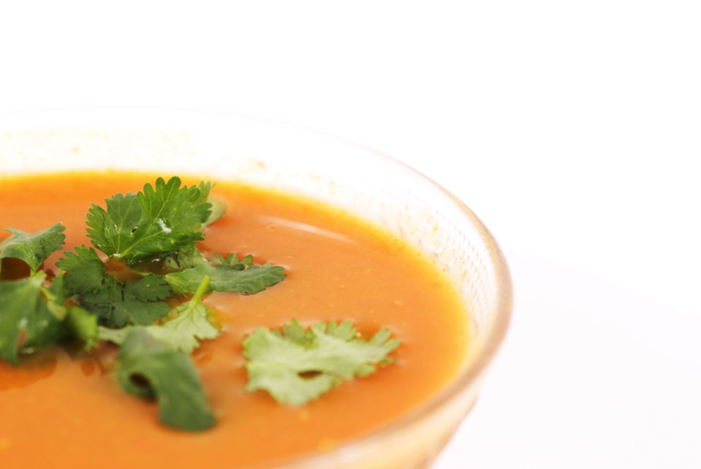 Closeup of delicious carrot soup with white background